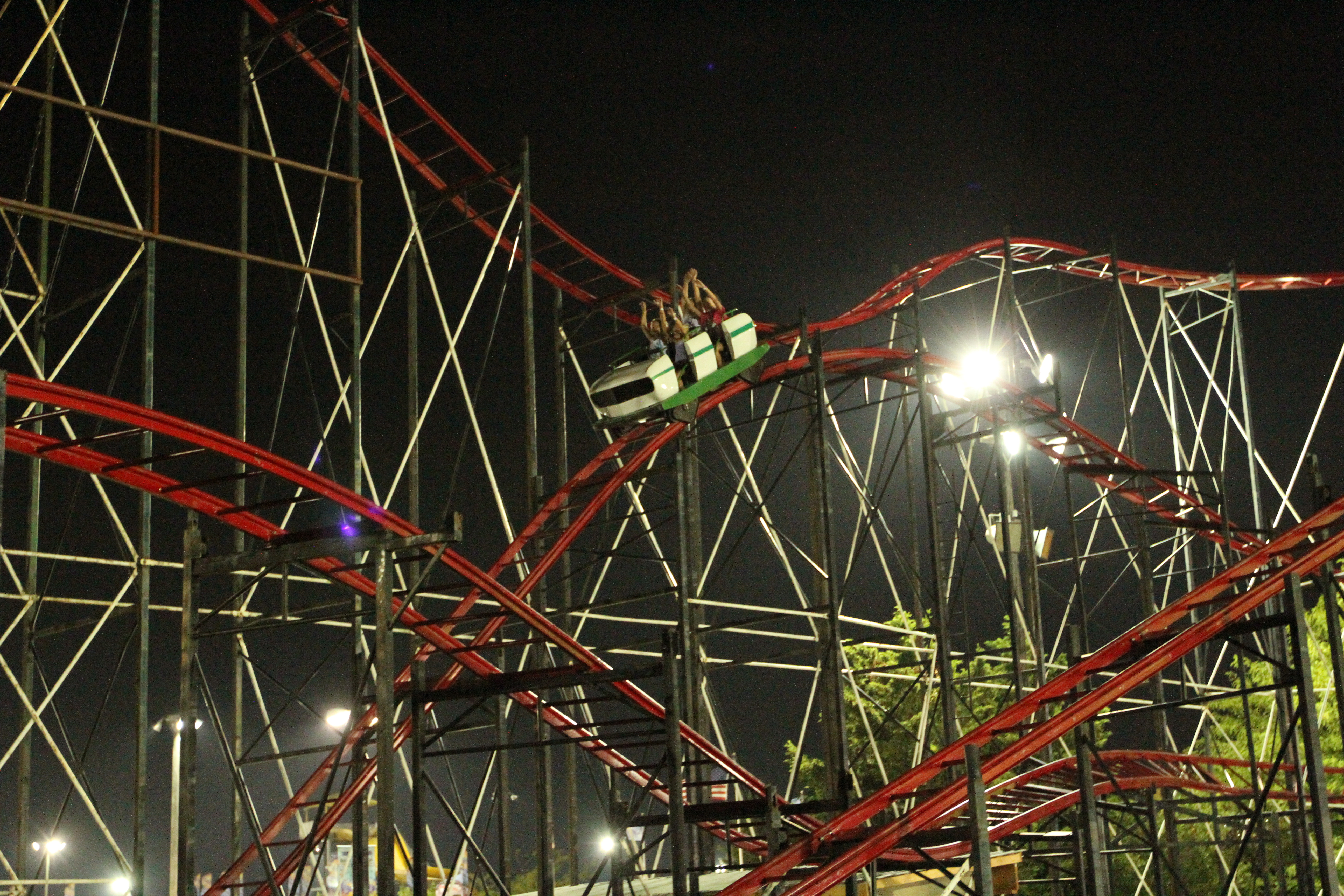 a red roller coaster at night