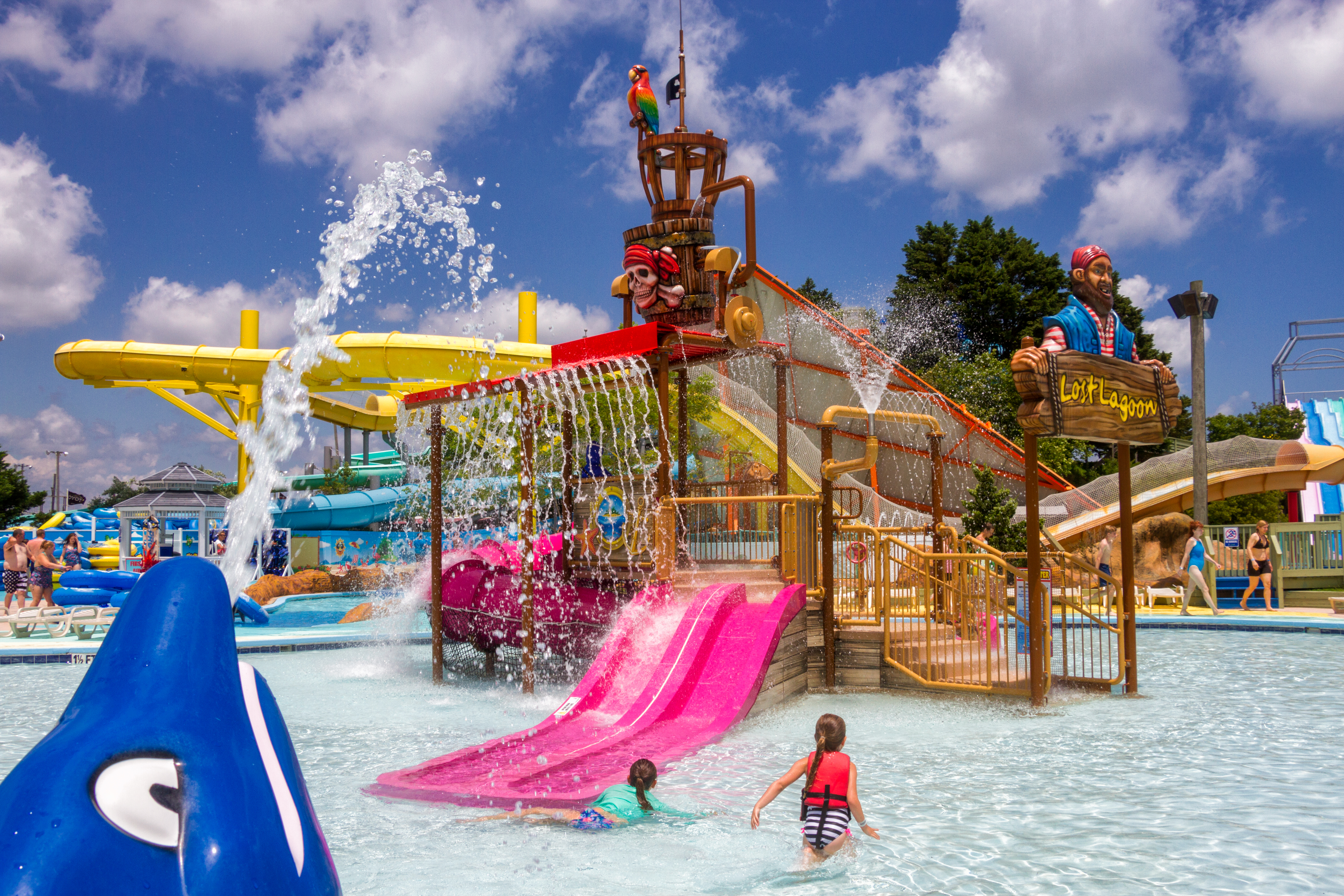 a childrens play area in a water park on a bright sunny day
