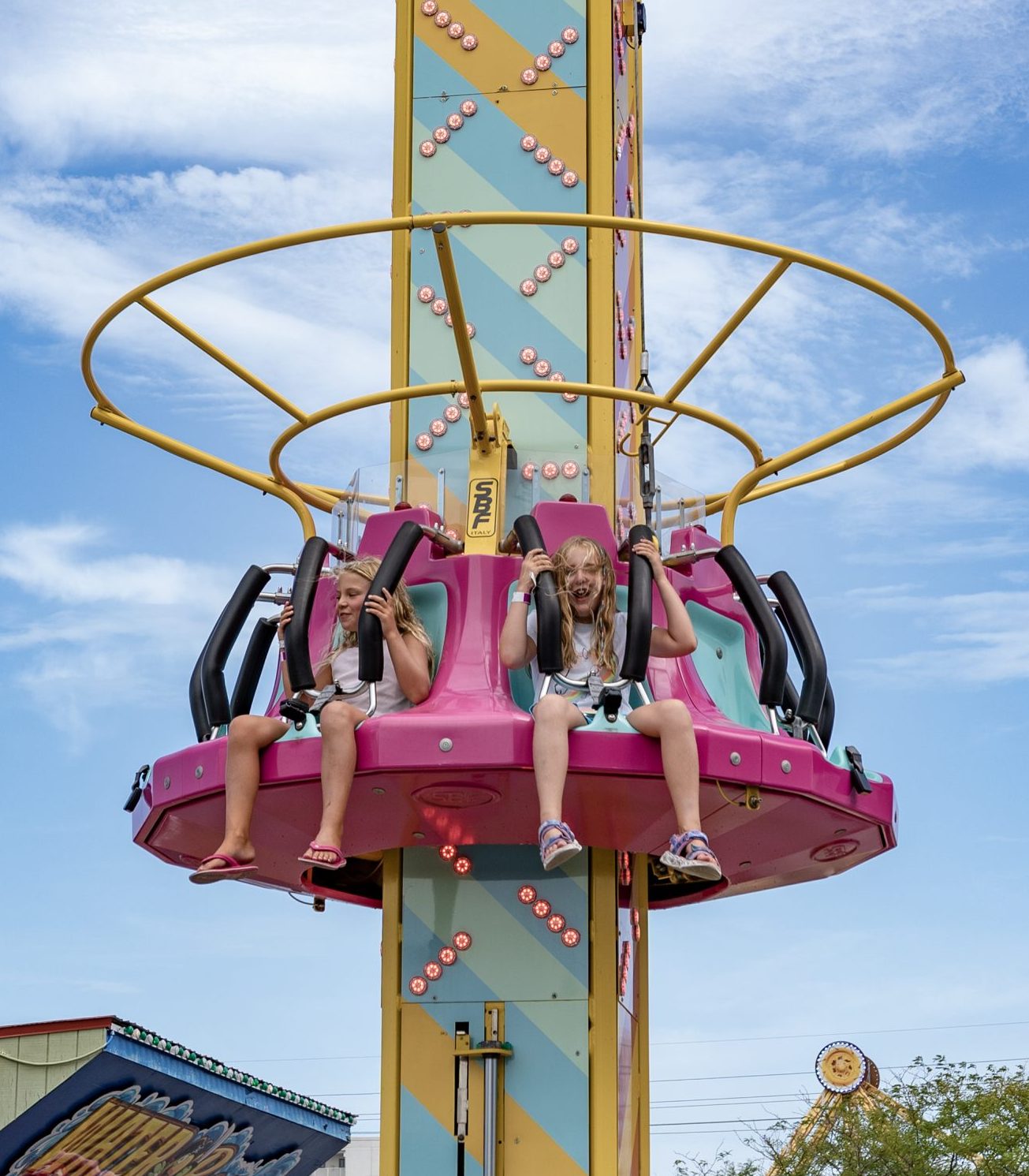 Pink and yellow drop ride at Jolly Roger