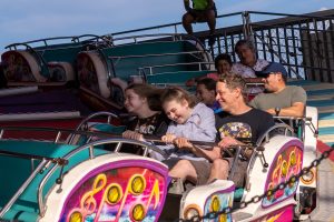 Families enjoying rides at the pier